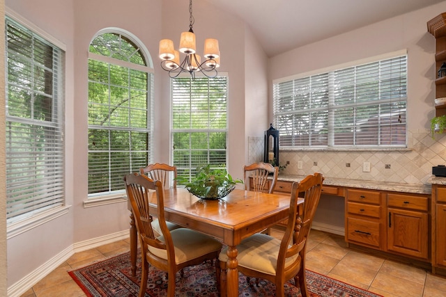 1869 Rio Blanco Dr, Frisco, TX 75033 - dining space featuring a chandelier, light tile patterned flooring, plenty of natural light, lofted ceiling, and baseboards