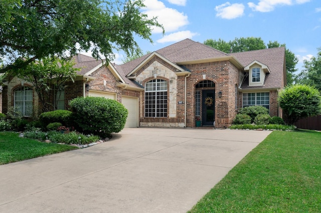 1869 Rio Blanco Dr, Frisco, TX 75033 - view of front of home with a garage, brick siding, driveway, and a front yard