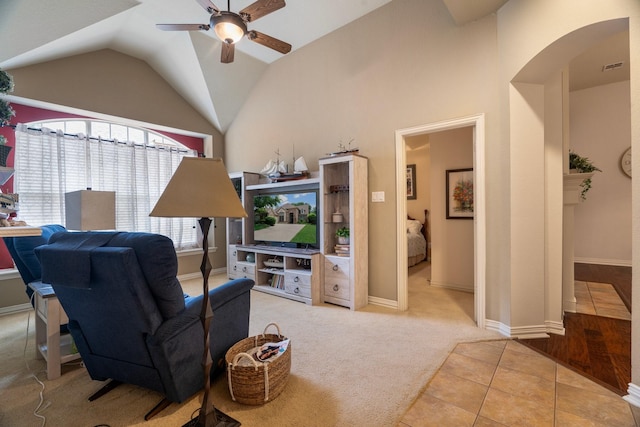 1869 Rio Blanco Dr, Frisco, TX 75033 - carpeted living area with a ceiling fan, lofted ceiling, arched walkways, tile patterned floors, and baseboards
