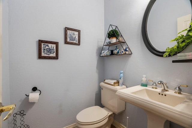 1869 Rio Blanco Dr, Frisco, TX 75033 - bathroom featuring toilet, a sink, and baseboards