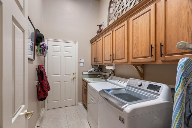 1869 Rio Blanco Dr, Frisco, TX 75033 - laundry area featuring washer and clothes dryer, cabinet space, light tile patterned flooring, and baseboards