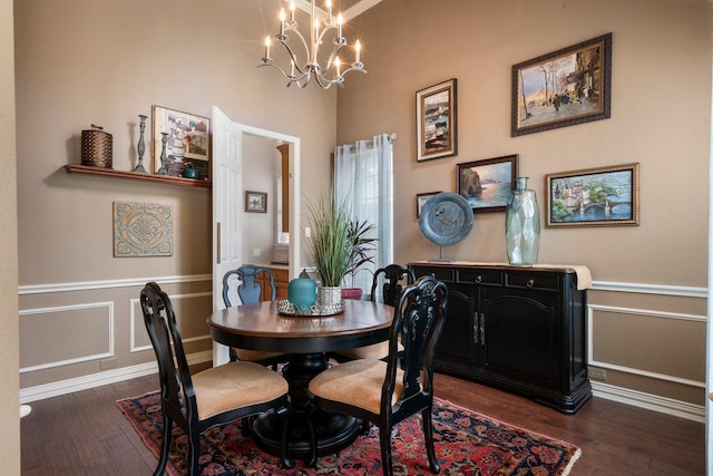 1869 Rio Blanco Dr, Frisco, TX 75033 - dining room with dark wood finished floors, a chandelier, wainscoting, a decorative wall, and baseboards