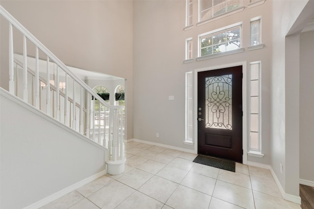 3448 Lark Meadow Way, Dallas, TX 75287 - entryway with a towering ceiling, baseboards, tile patterned floors, stairs, and healthy amount of natural light