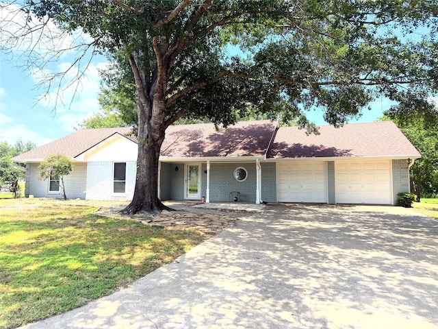 1111 Joel St, Groesbeck, TX 76642 - single story home featuring an attached garage, driveway, a front lawn, and brick siding