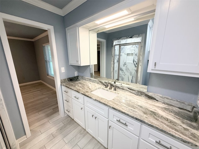 1111 Joel St, Groesbeck, TX 76642 - full bathroom featuring ornamental molding, vanity, wood finished floors, and a shower stall