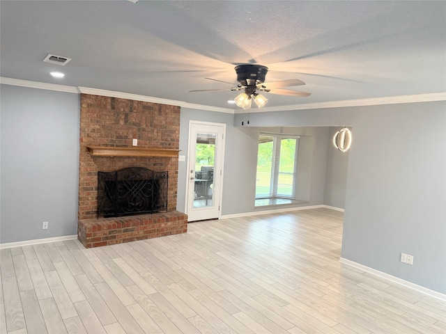 1111 Joel St, Groesbeck, TX 76642 - unfurnished living room with ceiling fan, light wood finished floors, ornamental molding, and a brick fireplace