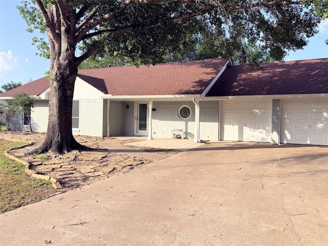 1111 Joel St, Groesbeck, TX 76642 - single story home featuring brick siding, an attached garage, concrete driveway, and roof with shingles
