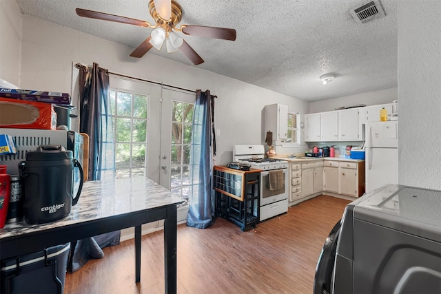 3812 Acree St, Beverly Hills, TX 76711 - kitchen featuring white appliances, a textured ceiling, light countertops, ceiling fan, and light wood finished floors