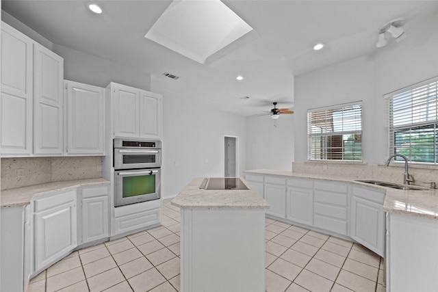 12020 Younger Ct, Azle, TX 76020 - kitchen with black electric stovetop, a sink, light tile patterned flooring, double oven, and a center island