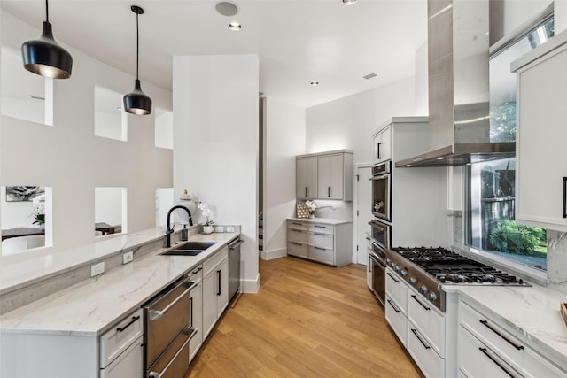 6617 Shady Creek Cir, Plano, TX 75024 - kitchen with a sink, range hood, appliances with stainless steel finishes, a peninsula, and gray cabinets