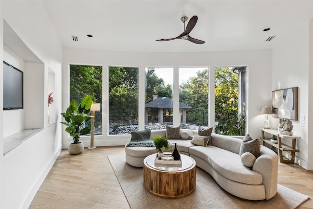 6617 Shady Creek Cir, Plano, TX 75024 - living area featuring healthy amount of natural light, a ceiling fan, wood finished floors, and baseboards
