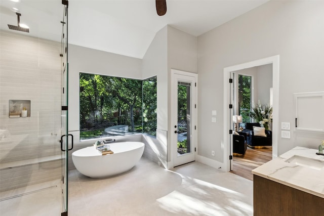 6617 Shady Creek Cir, Plano, TX 75024 - bathroom featuring a shower stall, vanity, a freestanding tub, a ceiling fan, and vaulted ceiling