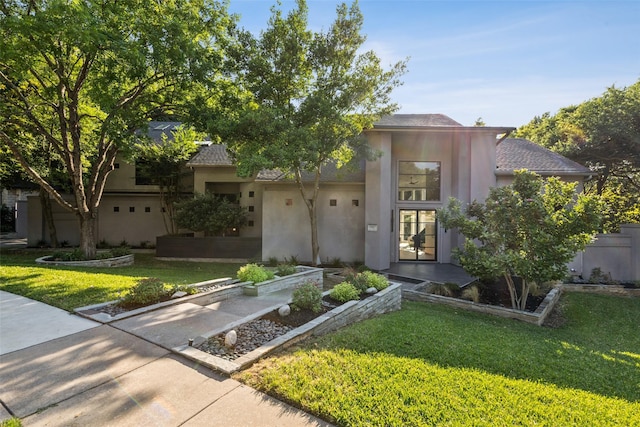6617 Shady Creek Cir, Plano, TX 75024 - view of front of property with stucco siding, a front lawn, and a shingled roof