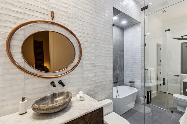 6617 Shady Creek Cir, Plano, TX 75024 - full bath with tile walls, a soaking tub, vanity, tile patterned floors, and a shower stall