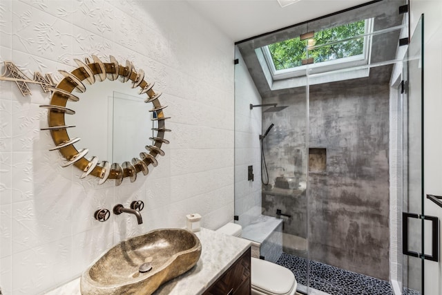 6617 Shady Creek Cir, Plano, TX 75024 - bathroom featuring a skylight, a shower stall, toilet, and vanity