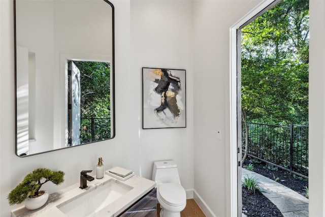 6617 Shady Creek Cir, Plano, TX 75024 - half bath featuring toilet, baseboards, vanity, and wood finished floors