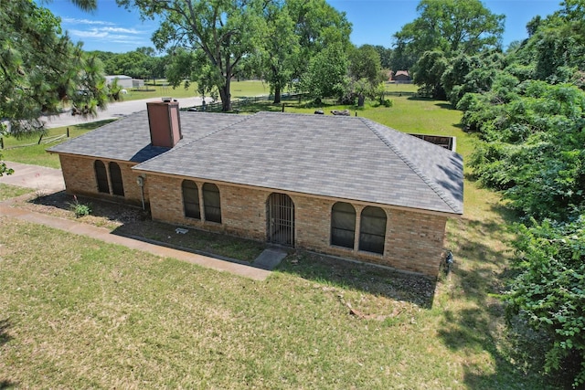 2701 Mims St, Fort Worth, TX 76112 - view of front of home featuring brick siding, a chimney, and a front lawn