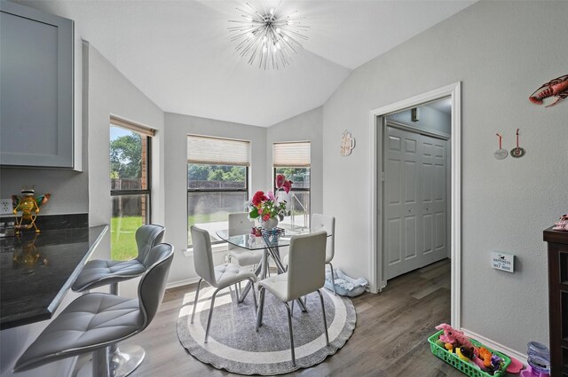 2701 Mims St, Fort Worth, TX 76112 - dining room with lofted ceiling, wood finished floors, a chandelier, and baseboards