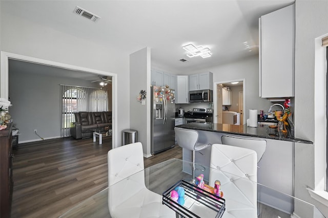 2701 Mims St, Fort Worth, TX 76112 - dining space with dark wood finished floors, a ceiling fan, and baseboards