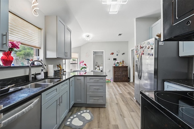 2701 Mims St, Fort Worth, TX 76112 - kitchen featuring stainless steel appliances, a sink, light wood-style flooring, a peninsula, and plenty of natural light