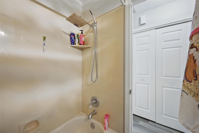 2701 Mims St, Fort Worth, TX 76112 - bathroom featuring  shower combination and wood finished floors