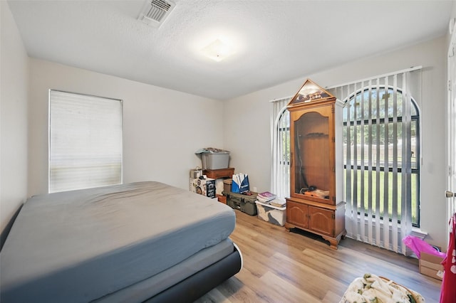 2701 Mims St, Fort Worth, TX 76112 - bedroom featuring wood finished floors and a textured ceiling
