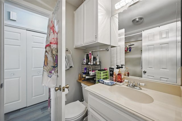 2701 Mims St, Fort Worth, TX 76112 - bathroom featuring vanity, toilet, and wood finished floors