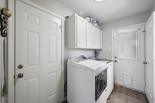 2701 Mims St, Fort Worth, TX 76112 - laundry room featuring washing machine and clothes dryer, cabinet space, and dark wood-style floors