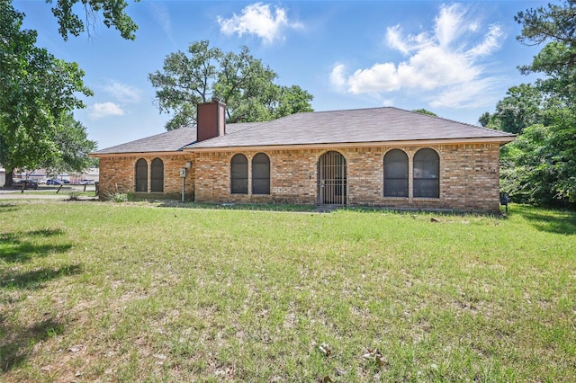 2701 Mims St, Fort Worth, TX 76112 - view of front of home with a front lawn, brick siding, and a chimney
