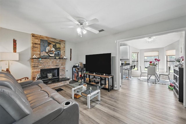 2701 Mims St, Fort Worth, TX 76112 - living room with light wood-style flooring, a ceiling fan, a fireplace, and baseboards