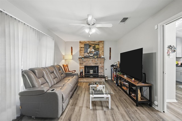 2701 Mims St, Fort Worth, TX 76112 - living room featuring ceiling fan, wood finished floors, a fireplace, and baseboards