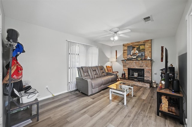 2701 Mims St, Fort Worth, TX 76112 - living area featuring ceiling fan, wood finished floors, and a brick fireplace