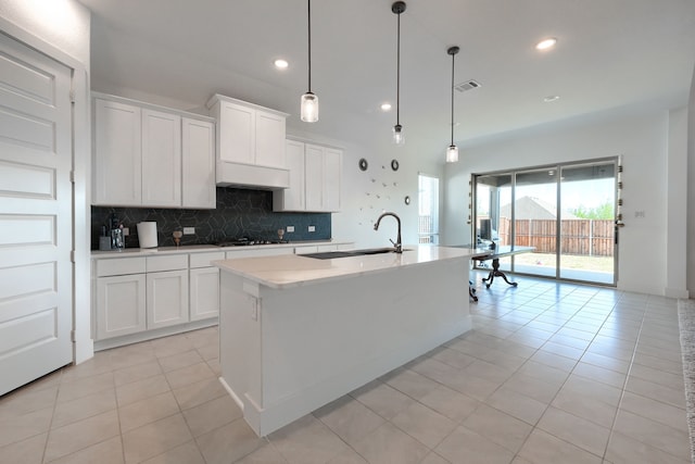 108 Laverna Ln, Hickory Creek, TX 75065 - kitchen featuring a sink, gas cooktop, decorative backsplash, light tile patterned floors, and light countertops
