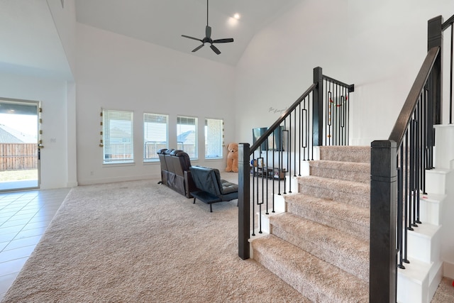 108 Laverna Ln, Hickory Creek, TX 75065 - staircase featuring high vaulted ceiling, ceiling fan, carpet, baseboards, and tile patterned flooring
