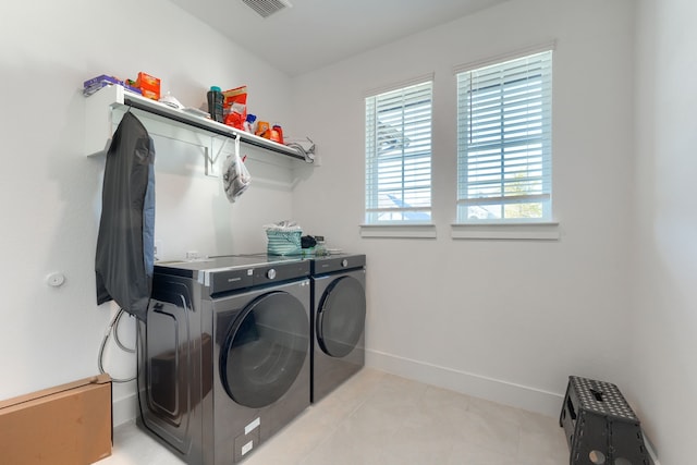 108 Laverna Ln, Hickory Creek, TX 75065 - washroom featuring washing machine and clothes dryer, light tile patterned floors, and baseboards