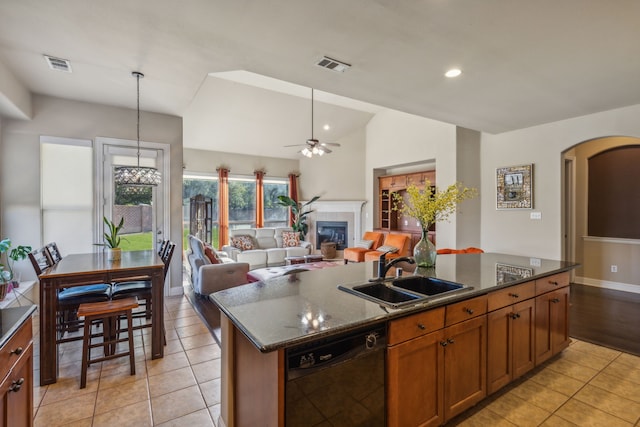 5736 New Castle Dr, Richardson, TX 75082 - kitchen featuring black dishwasher, a sink, arched walkways, light tile patterned floors, and ceiling fan