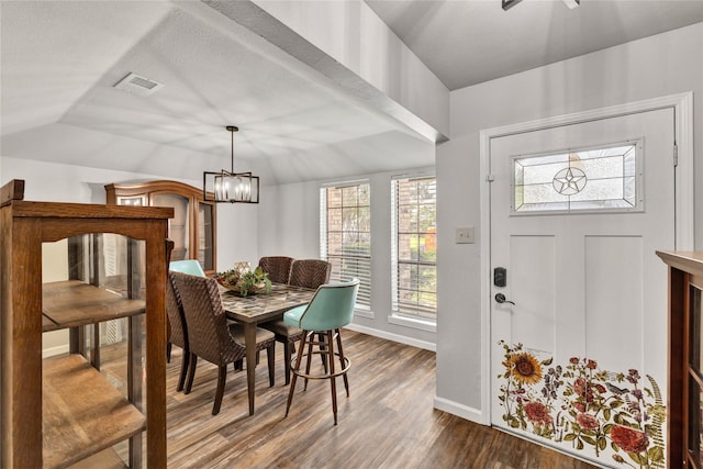 1603 Versailles Dr, Richardson, TX 75081 - dining area with dark wood-type flooring, baseboards, lofted ceiling, and a chandelier