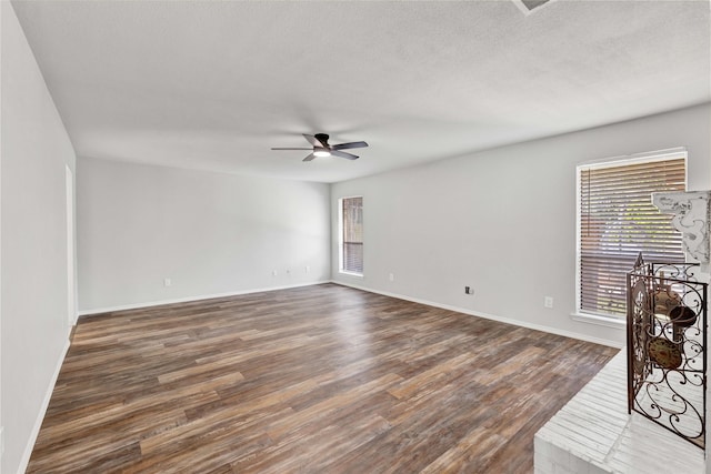 1603 Versailles Dr, Richardson, TX 75081 - empty room with dark wood-type flooring, a ceiling fan, baseboards, and a textured ceiling