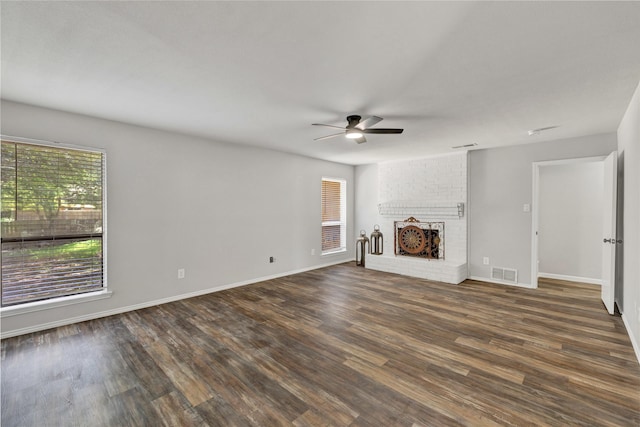 1603 Versailles Dr, Richardson, TX 75081 - unfurnished living room with a ceiling fan, a fireplace, dark wood-style flooring, and baseboards