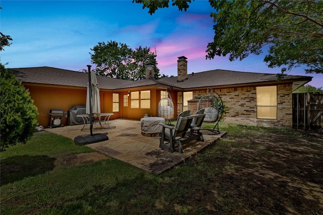 1603 Versailles Dr, Richardson, TX 75081 - rear view of house featuring a chimney, a patio, brick siding, and roof with shingles