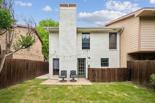 223 Mccarley Pl, Mckinney, TX 75071 - rear view of house featuring a chimney, brick siding, and a patio