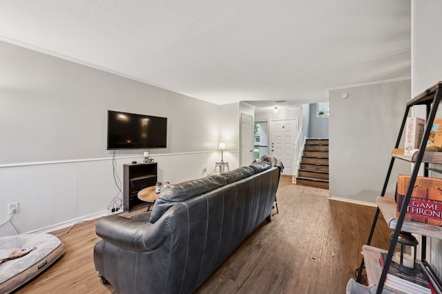 223 Mccarley Pl, Mckinney, TX 75071 - living room with stairway, wood finished floors, and wainscoting