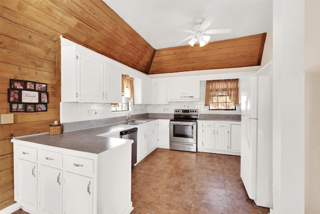 691 Bear Rd, Van Alstyne, TX 75495 - kitchen featuring stainless steel appliances, ceiling fan, white cabinets, a sink, and wooden walls