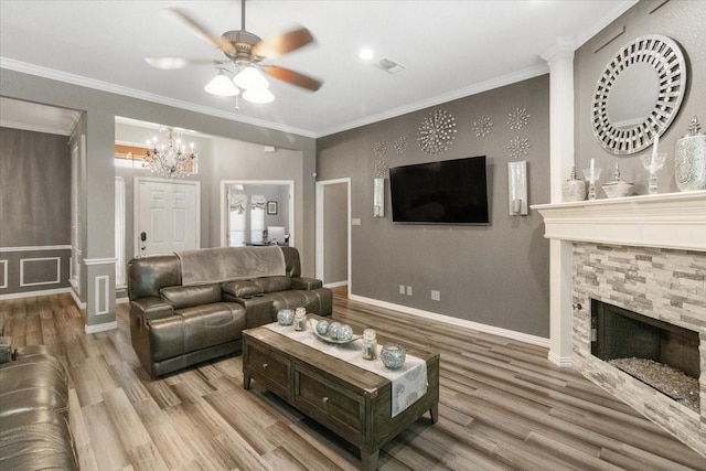 810 W Lonesome Dove Trl, Arlington, TX 76001 - living room with wood finished floors, a ceiling fan, a chandelier, a stone fireplace, and crown molding