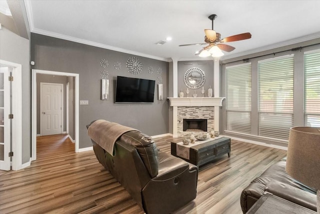 810 W Lonesome Dove Trl, Arlington, TX 76001 - living area with ornamental molding, ceiling fan, wood finished floors, a stone fireplace, and baseboards