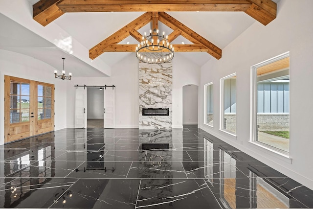 10611 Millet Ln, Venus, TX 76084 - living room with a chandelier, high vaulted ceiling, beam ceiling, baseboards, and a barn door