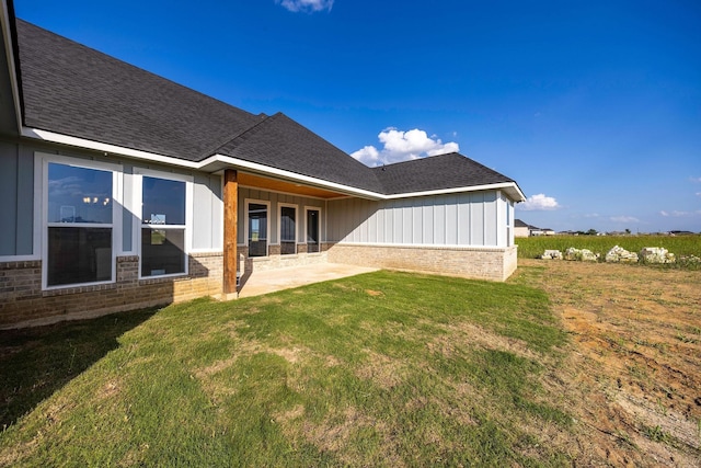 10611 Millet Ln, Venus, TX 76084 - rear view of property with brick siding, roof with shingles, a patio area, and board and batten siding