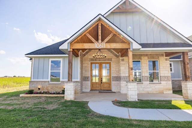 10611 Millet Ln, Venus, TX 76084 - craftsman inspired home featuring board and batten siding, roof with shingles, french doors, stone siding, and a front lawn