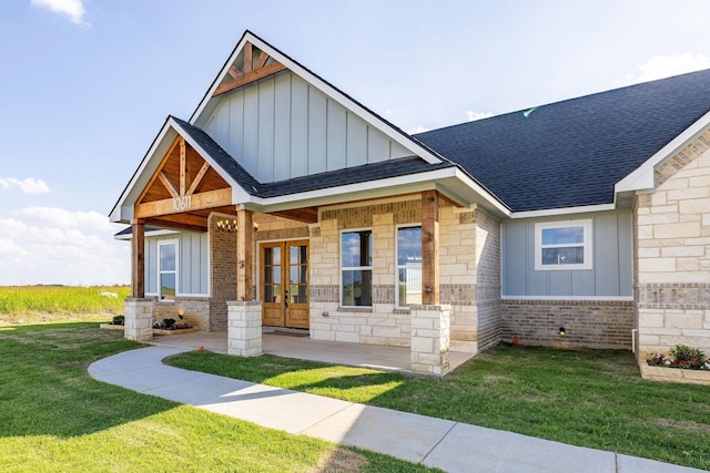 10611 Millet Ln, Venus, TX 76084 - view of front of house featuring board and batten siding, french doors, roof with shingles, a front lawn, and stone siding