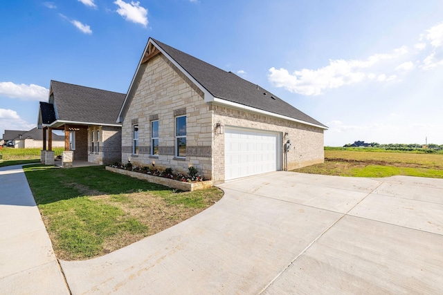 10611 Millet Ln, Venus, TX 76084 - view of property exterior with roof with shingles, stone siding, a yard, driveway, and an attached garage